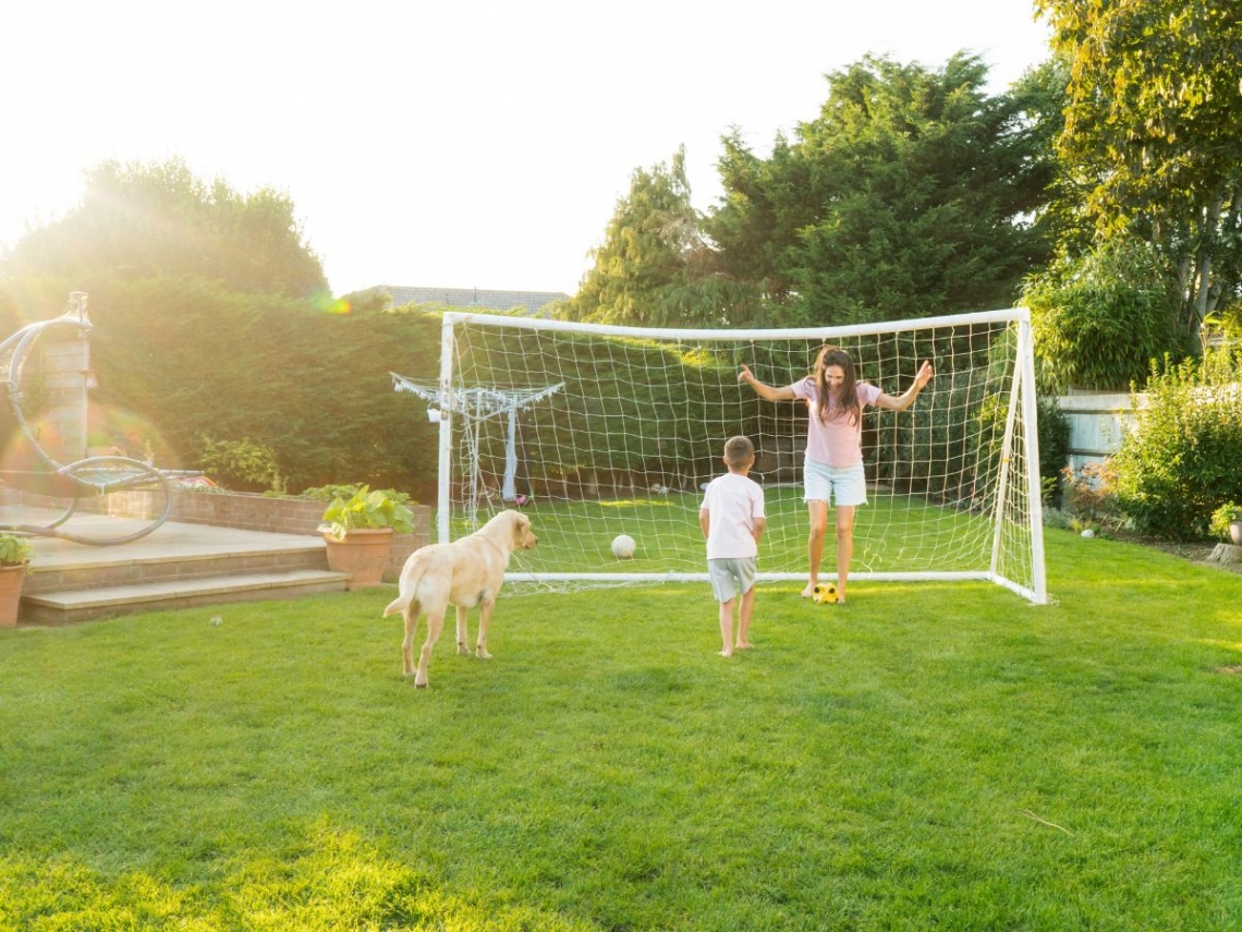 a mother and son playing soccer in their backyard.jpg
